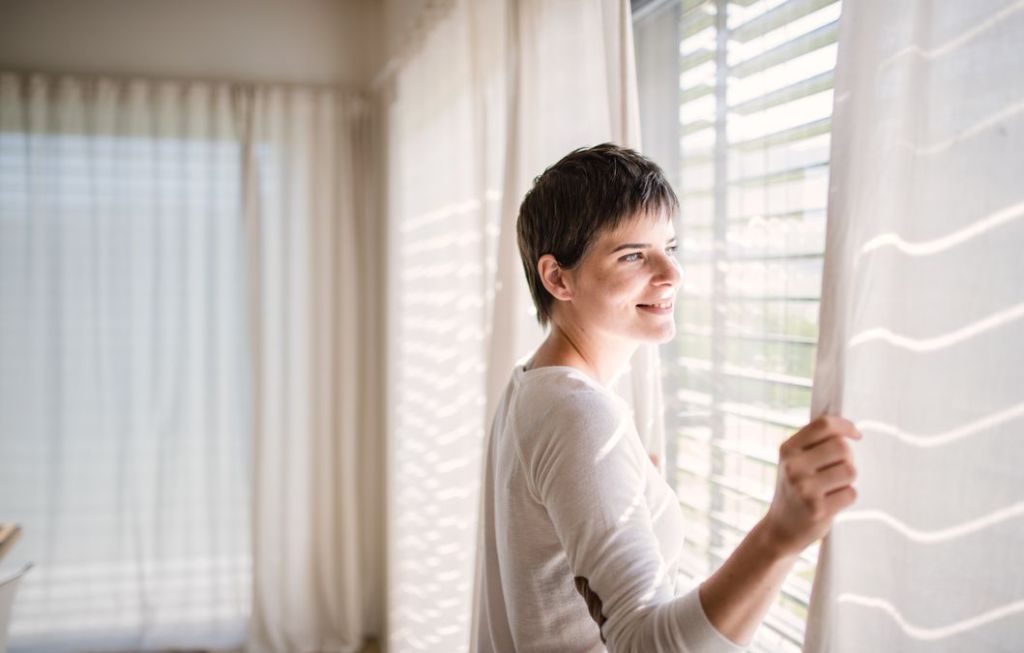 woman looking at window